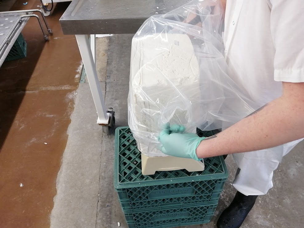 How cheese is made - vacuum packing of the cheese blocks